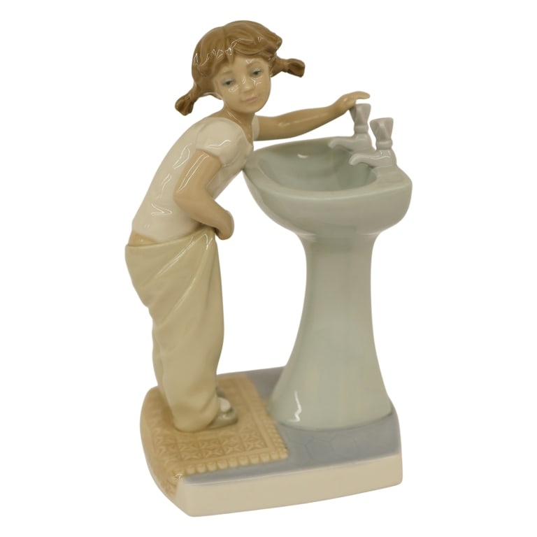 Lladro "Clean Up Time" Porcelain Figurine: Item/Description: Lladro "Clean Up Time" (#4838) porcelain figurine, designed by Julio Fernandez. Issued in 1973 and retired from production in 1998. Figurine depicts a young girl with braided pigtail