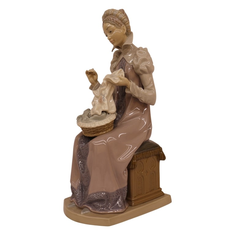 Lladro "Sewing a Trousseau" Porcelain Figurine: Item/Description: Lladro "Sewing a Trousseau" (#5126) porcelain figurine, designed by Salvador Furio. Issued in 1982 and retired from production in 1989. Composition depicts an elegant, medieval-style