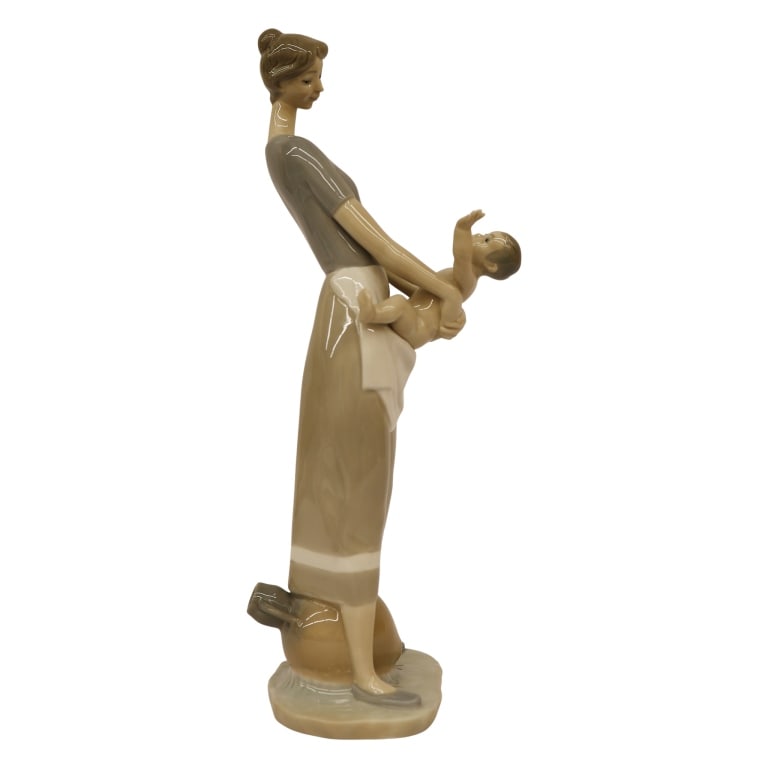 Lladro "Mother and Child" Porcelain Figurine: Item/Description: Lladro "Mother and Child" (#4575) porcelain figurine, designed by Fulgencio Garcia. Issued in 1969 and retired in 1997. Figurine depicts an adoring, mother styled in mid-century atti