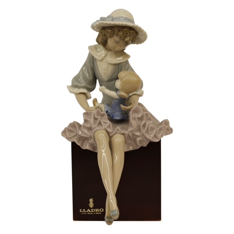 Lladro "Debbie and Her Doll" Porcelain Figurine: Item/Description: Lladro "Debbie and Her Doll" (#1379) porcelain figurine, designed by Salvador Debon. Issued in 1978 and retired in 1985. Features a young girl in a wide, ruffled straw sun hat elegan