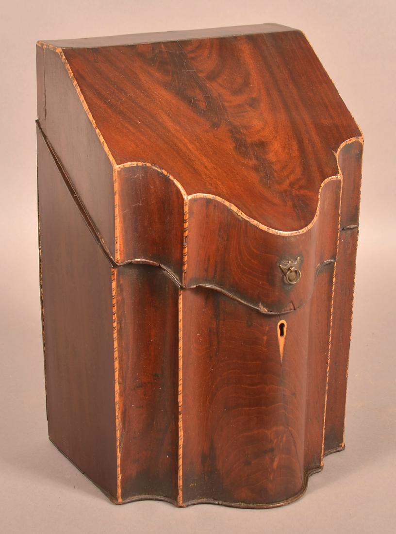 Federal Mahogany Veneered Serpentine Front Knife Box.: Federal Burl Mahogany Veneered Serpentine Front Knife Box. Hinged slant lid, inlaid trim with bone key escutcheon. 14-1/4"h. x 9"w. x 7-1/2"d. Condition: Good, fitted interior is completely missing, m