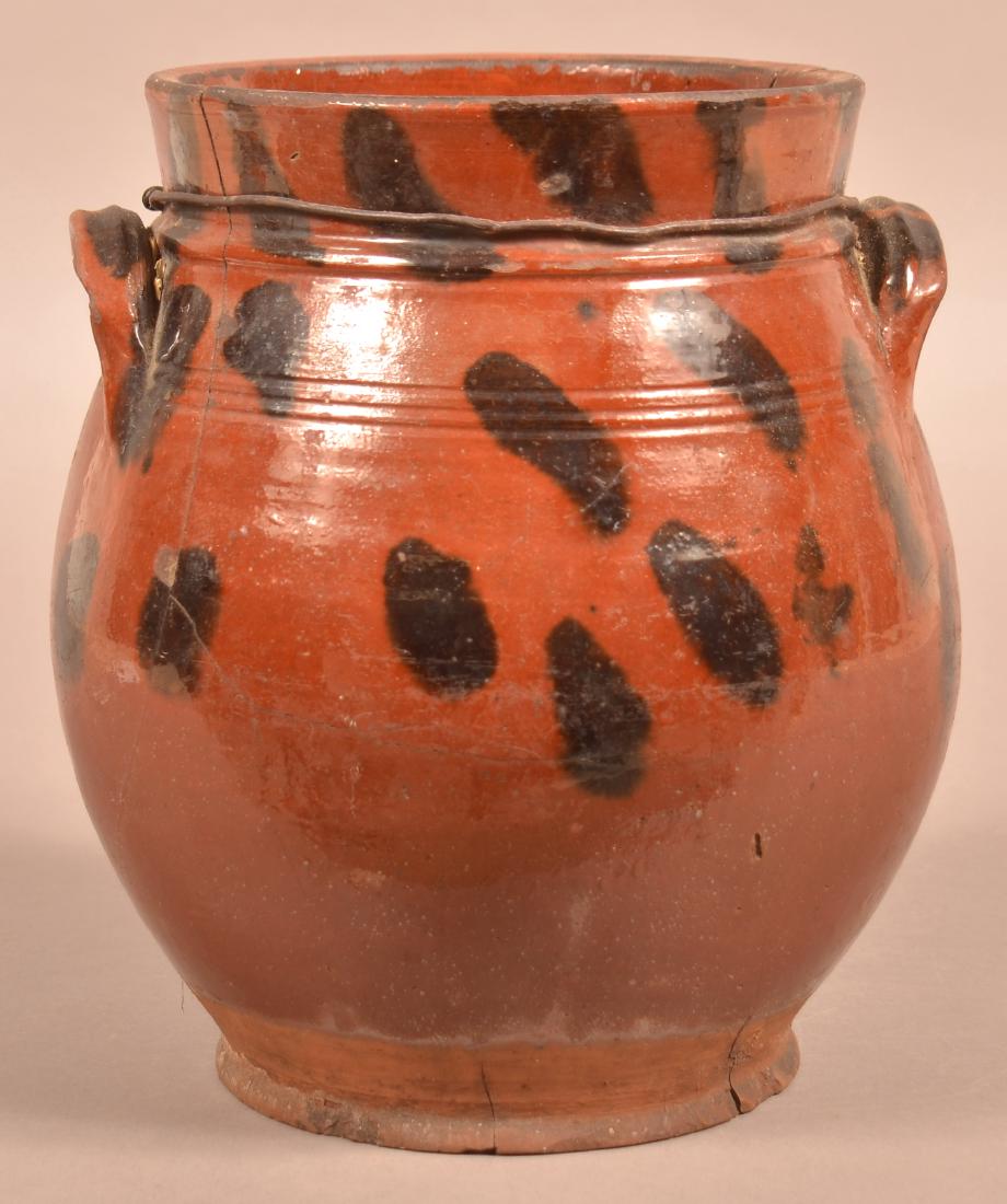 Pennsylvania 19th Century Brush-glazed Redware Jar.: Pennsylvania 19th Century Brush-glazed Redware Jar. 10"h. Condition: poor with cracks and chips. Reinforced with wire on collar.
