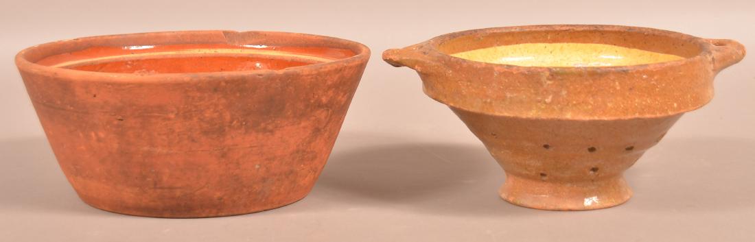 French 19th century Redware Bowl and Colander.: French 19th century Redware Bowl and Colander. Bowl measures 4-3/4" x 11-1/2", colander measures 5"h. x 12"w. at handles. Condition: Good with glazing wear and chips.