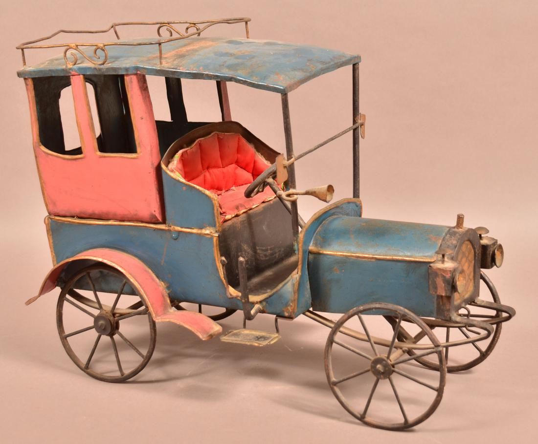 Vintage Hand Crafted Sheet Metal Automobile.: Vintage Hand Crafted Folk Art Sheet Metal Automobile. Painted blue and red. 14-3/4"h. x 20-1/2"l. Condition: Good with wear and scattered rust.