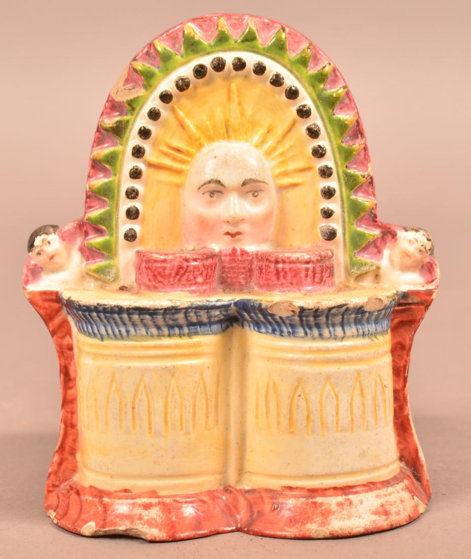Pratt Ware Glazed Earthenware Window Stop.: Rare Pratt Ware Glazed Earthenware Window Stop. Polychrome decorated with Sun face and cherubs. 5"h. Condition: Good with several chips.