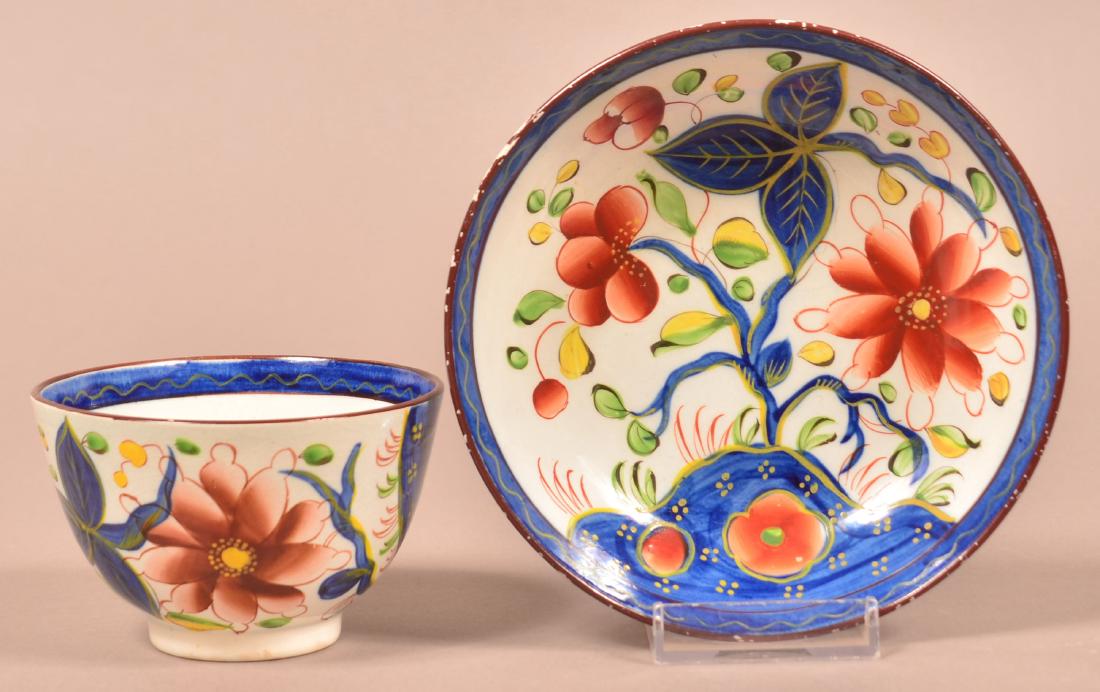 Gaudy Dutch China "Sunflower" Cup and Saucer.: Gaudy Dutch Sunflower Pattern Soft Paste China Cup and Saucer. Green and yellow leaves. Saucer measures 5-1/2" diam. Condition: Very good with edge wear on saucer.