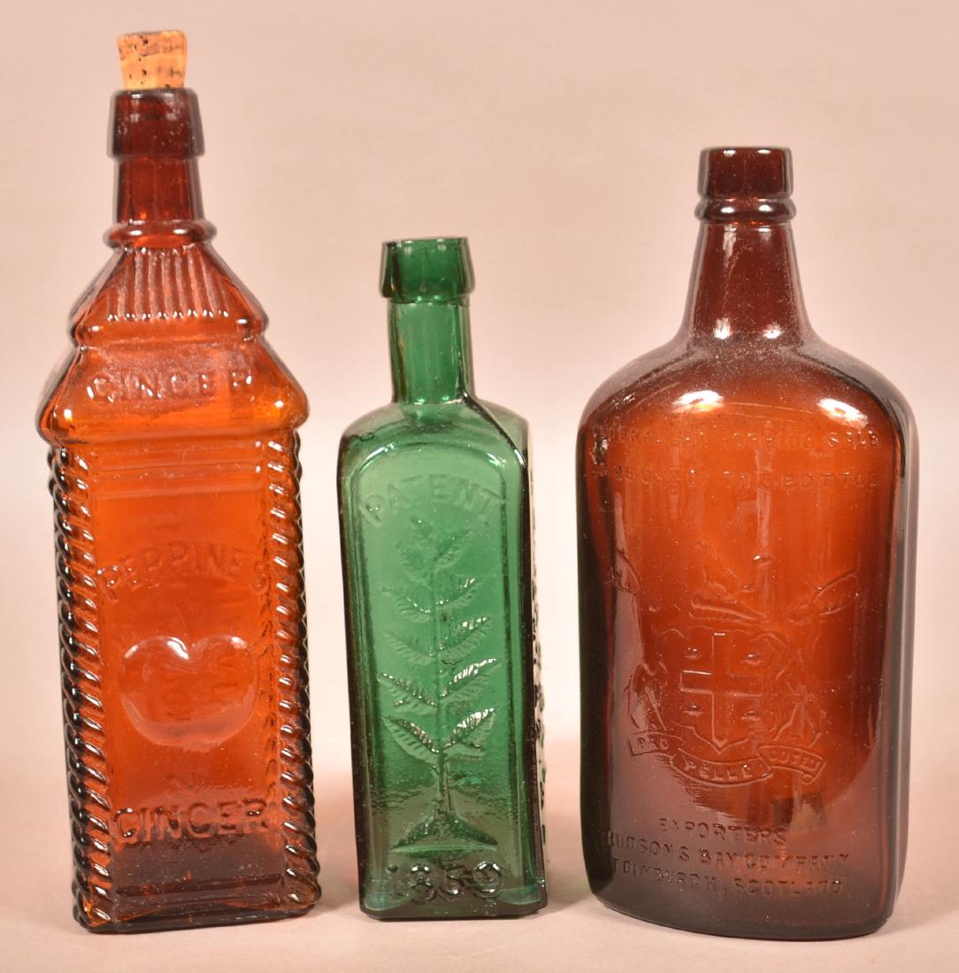 Three Various Colored Glass Bottles. (1 of 3)