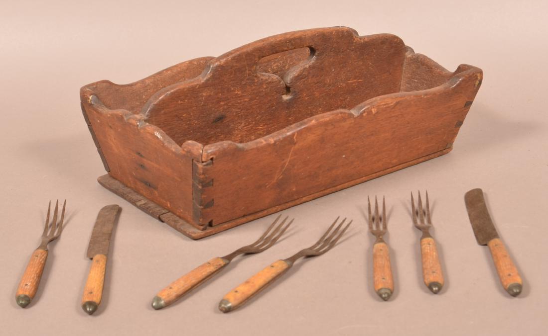 Antique Walnut Utensil Carrier.: Antique Walnut Utensil Carrier. Serpentine sides with dovetailed construction. Accompanied with some period bone handled knives and forks. 6"h. x 14-1/2"w. x 9-1/2"d. Condition: Good with use wear.