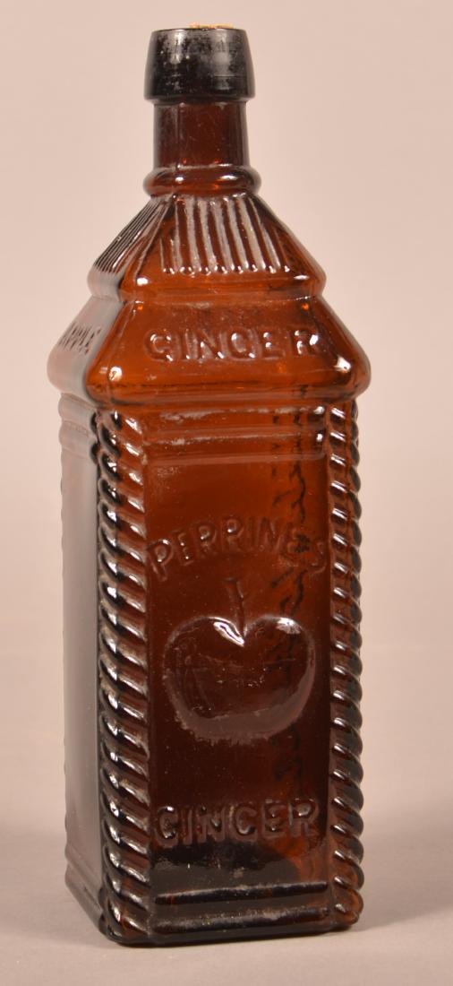 Perrines Apple Ginger Amber Glass Bitters Bottle.: Amber Glass Bitters Bottle "PERRINE'S APPLE GINGER". Decorated with rope trim on corners, apple design, one side reads "DEPOT; NO 37 NORTH FRONT STREET PHILA". 10"h. Condition: Very good.