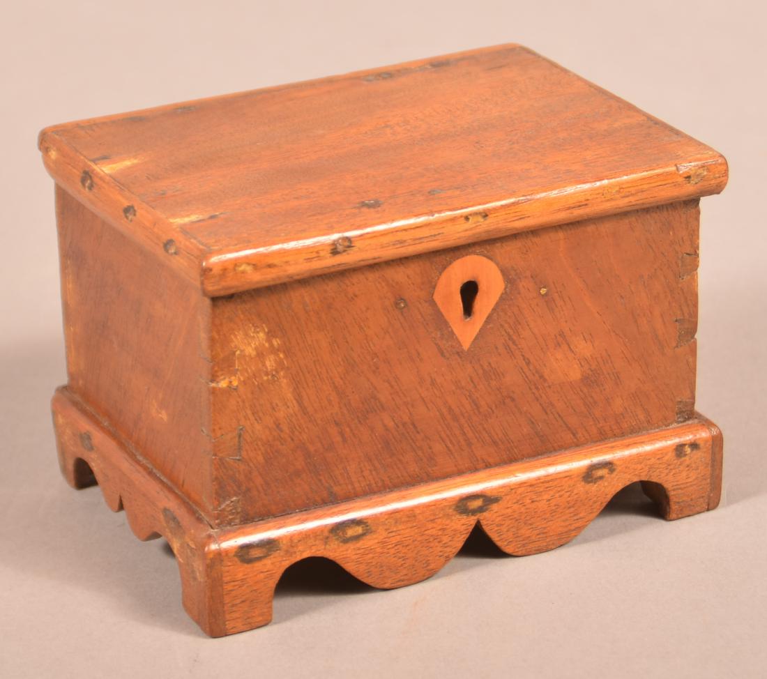19th Century Miniature Mahogany Blanket Chest.: 19th Century Miniature Mahogany Blanket Chest. Molded lid, interior till with lower drawer, reverse teardrop key escutcheon, dovetailed case and scalloped bracket base. 3-1/8"h. x 4-3/4"w. x 3-1/2"d. 