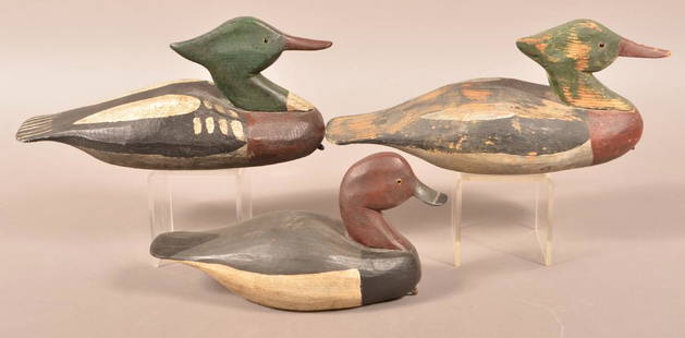 3 Romie Waterfield Carved Duck Decoys.: Three Carved Duck Decoys. All identified on tags by Romie Waterfield, Knotts Island, NC. Painted in natural colors. Two Mergansers, 13-1/2"l. and 14"l., and a Redhead Drake, 12"l. Condition: Good with