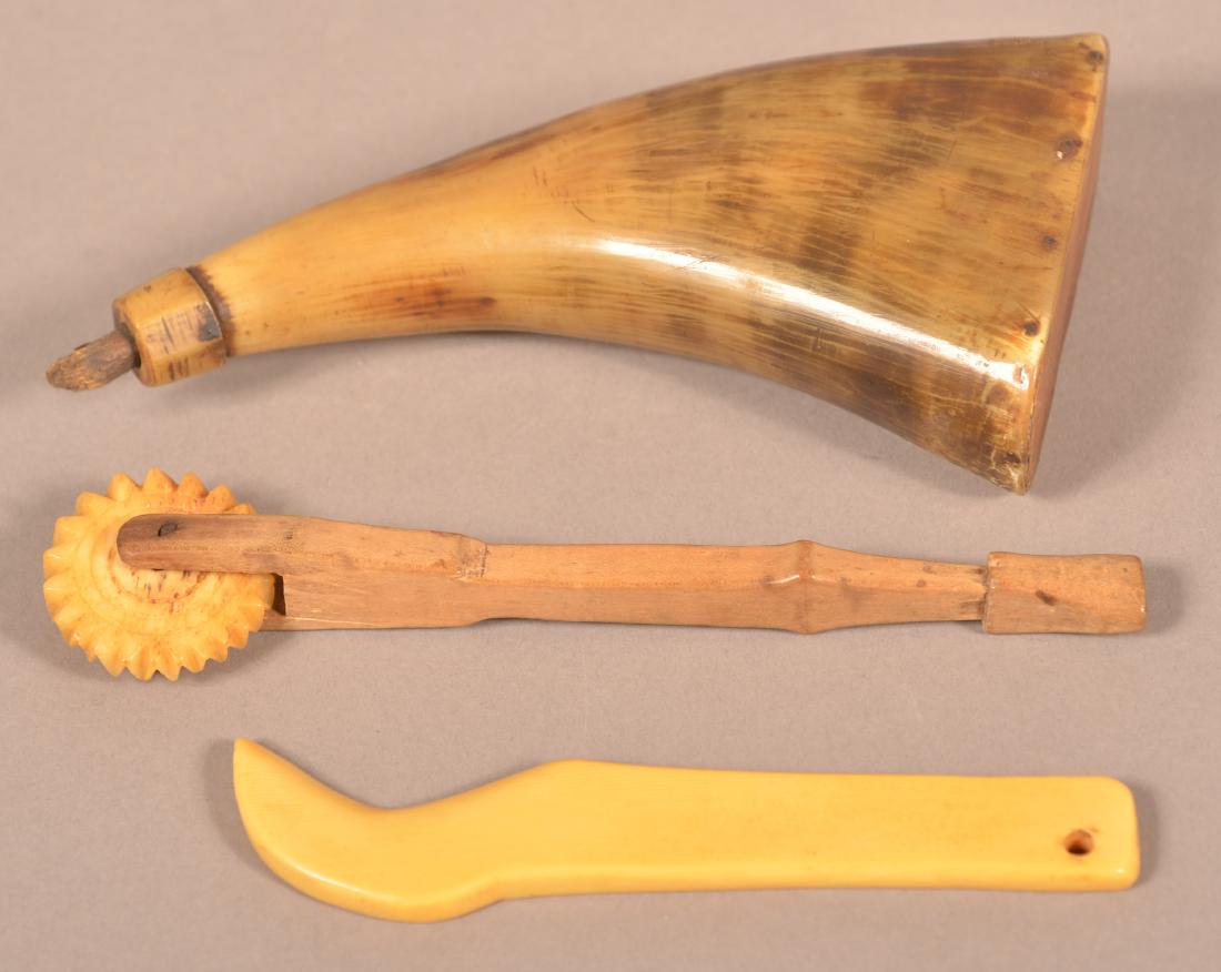 Three Pieces of Antique Horn and Bone.: Three Pieces of Antique Horn and Bone. Flat powder horn, 5-1/2", bone pie crimper with carved wood handle, 5-1/4"l. and bone bird head pie tool, 5"l. Condition: Good with use wear.