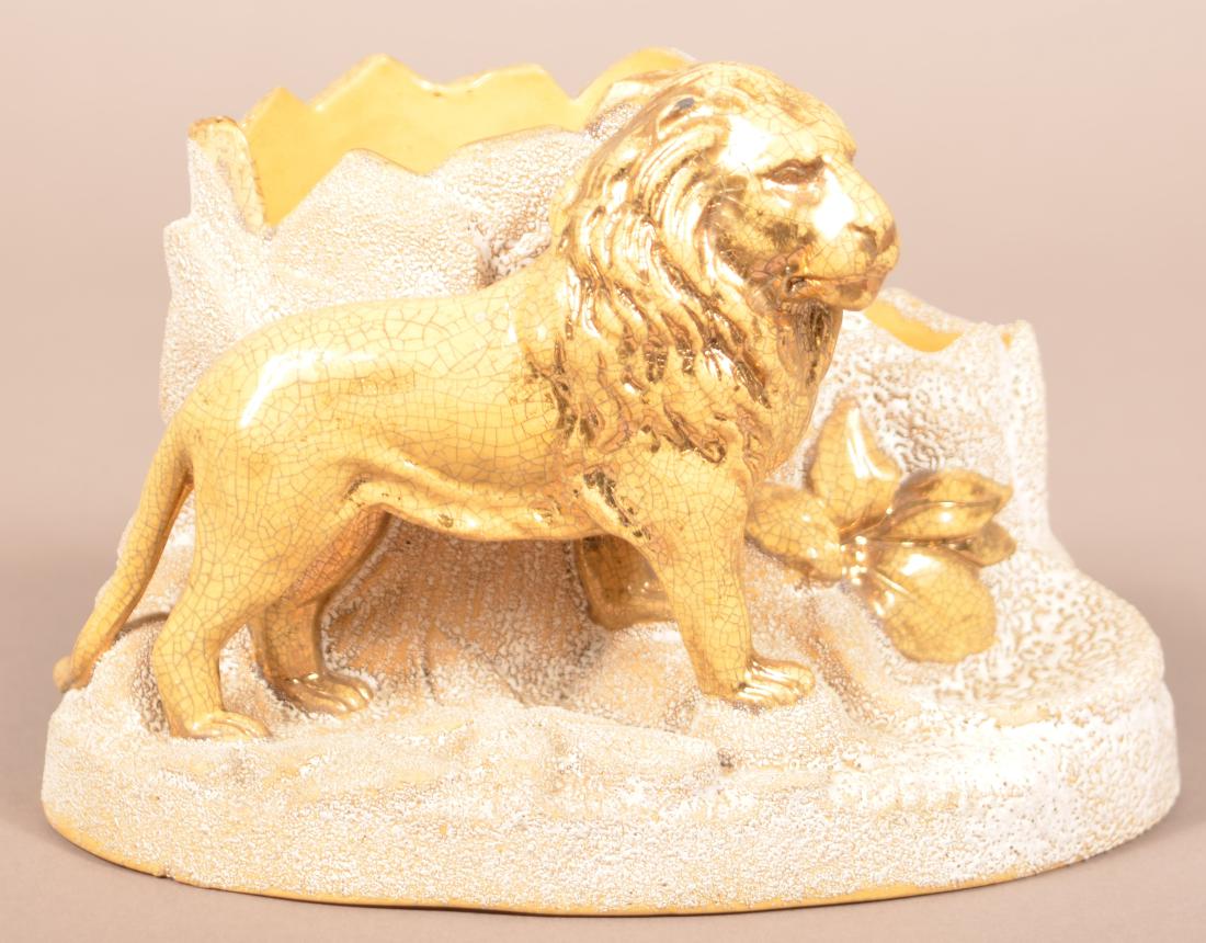 English Yellowware Cigar and Match Holder.: English Yellowware Cigar and Match Holder. Opaque white glaze with gilt highlights. Male lion by rock formations design. Base stamped "BB 2370". 5-3/4"h. Condition: Good with minor base chips and craz