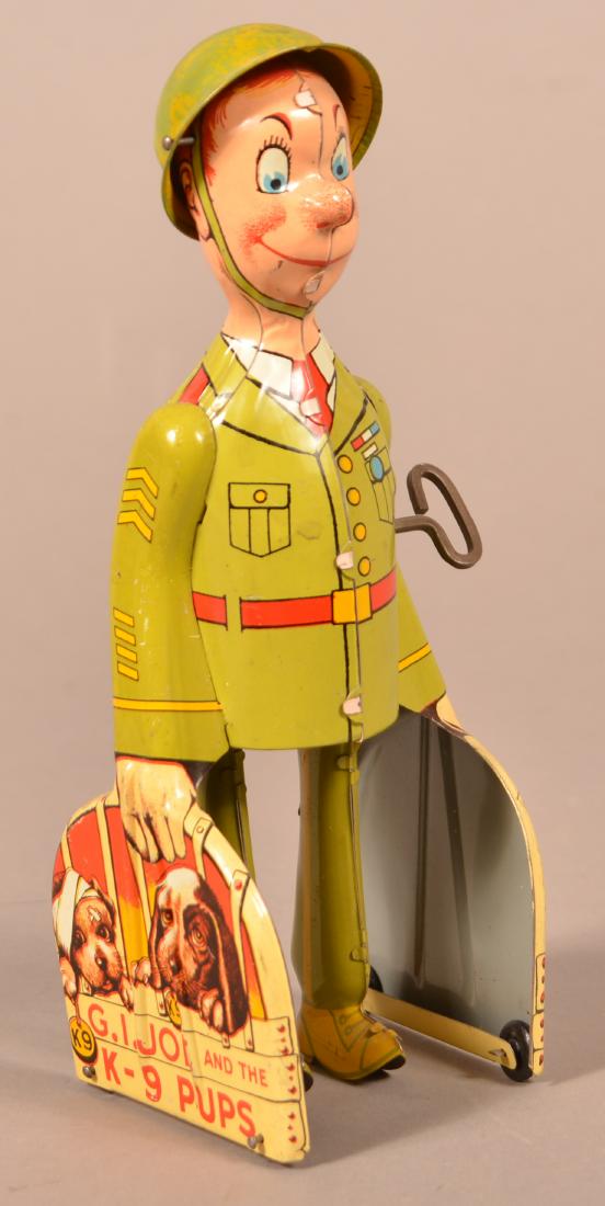 Unique Art "G.I. Joe and the K-9 Pups" Tin Wind-up Toy.: Unique Art "G.I. Joe and the K-9 Pups" Tin Lithograph Wind-up Toy. 9"h. Condition: Good with minor wear, working.