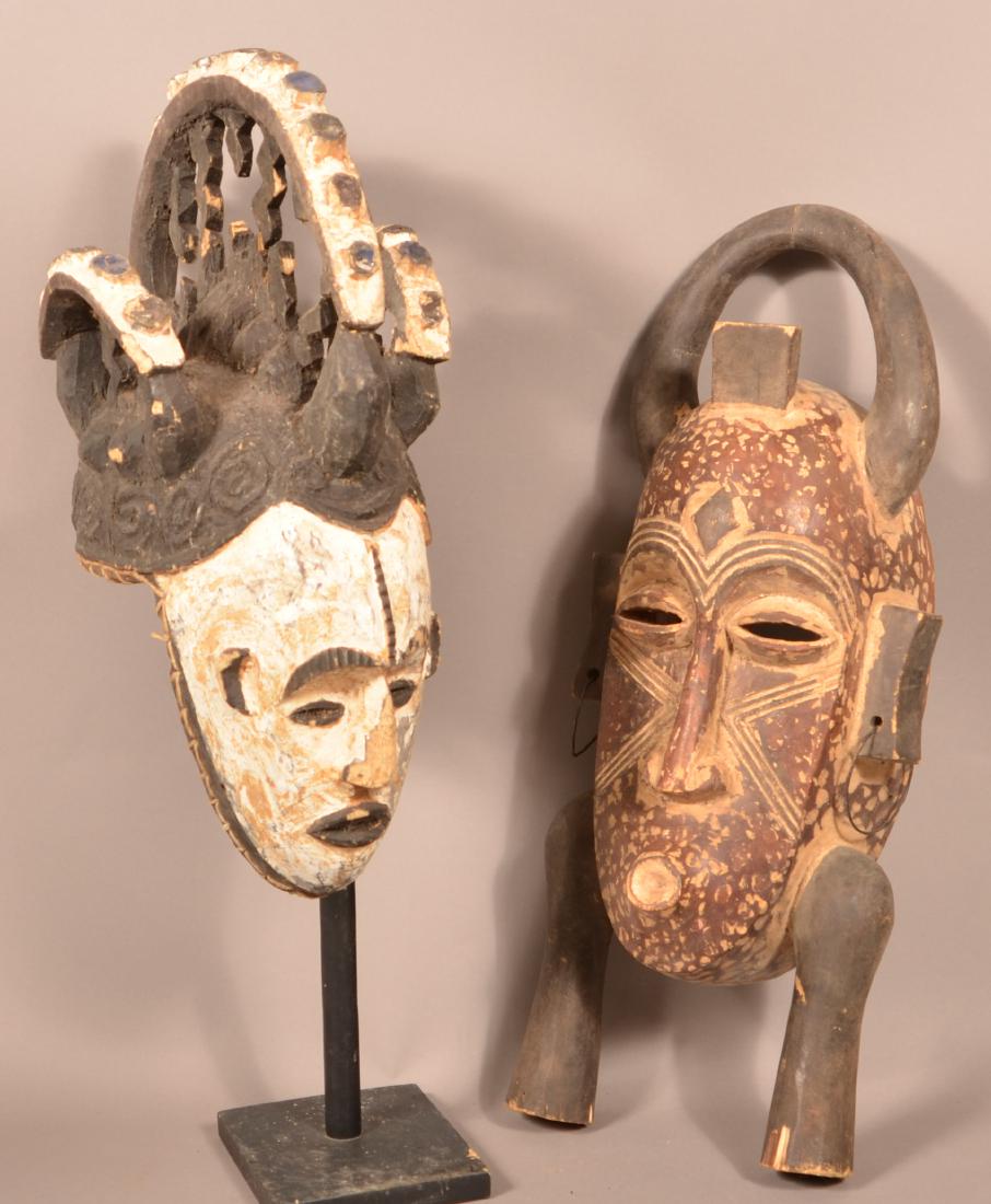 Two Antique/Vintage African Carved Wood Tribal Masks.: Two Antique/Vintage African Carved Wood Tribal Masks. Tallest 24-1/2"h. Condition: Fair to good with wear, cracks and losses.