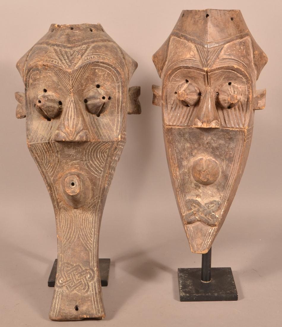 Two Antique/Vintage African Carved Wood Tribal Masks.: Two Antique/Vintage African Carved Wood Tribal Masks. Tallest measures 28"h. Condition: Fair to good with wear, cracks and losses.