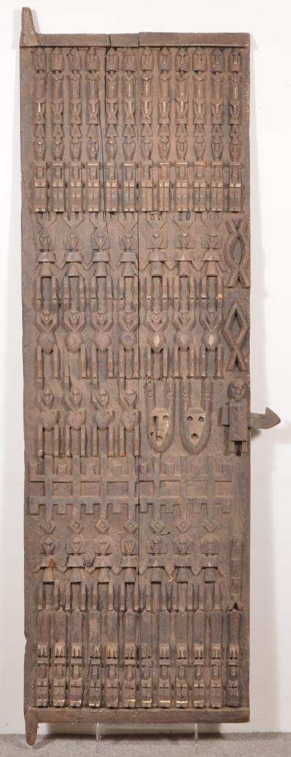 Two Antique/Vintage African Carved Wood Tribal Doors.: Two Antique/Vintage African Carved Wood Tribal Doors. 75"h. x 25"w. and 67"h. x 24-1/2"w. Condition: Good with wear and age cracks.