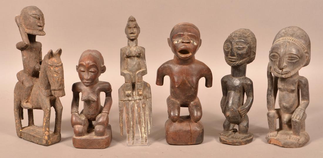 Seven Antique/Vintage African Carved Wood Tribal: Seven Antique/Vintage African Carved Wood Tribal Figures. Tallest measures 13"h. Condition: Good with wear and age cracks.