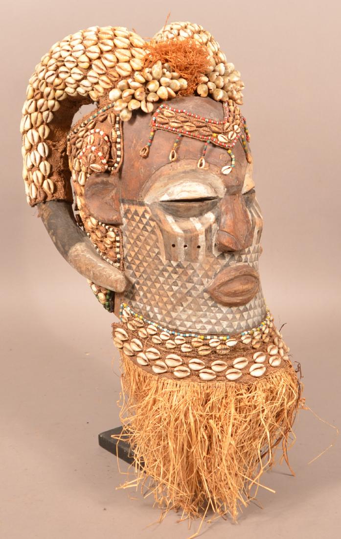 Antique/Vintage African Carved Wood Tribal Mask. With: Antique/Vintage African Carved Wood Tribal Mask. With shell and bead decoration. 20"h. Condition: Good with wear, cracks and losses.