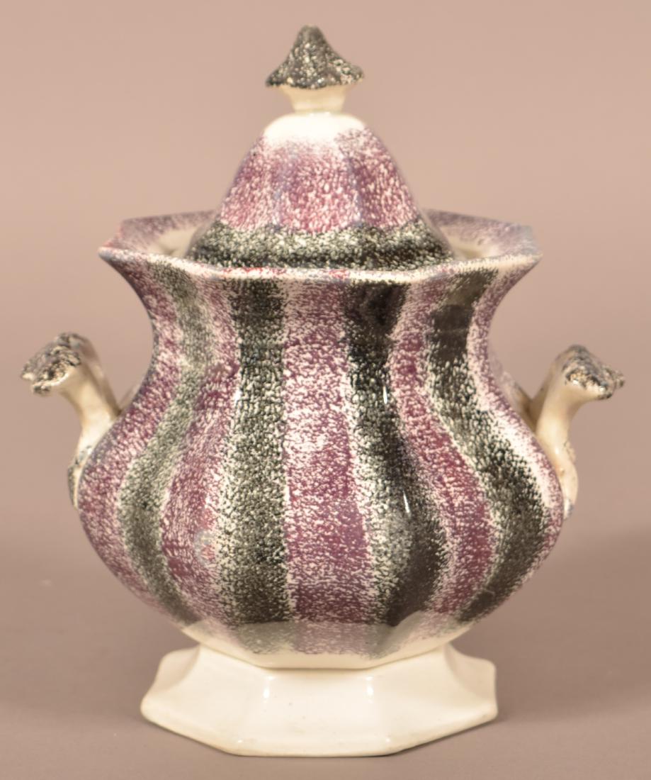 Purple and Black Rainbow Spatter Ironstone China: Purple and Black Rainbow Spatter Ironstone China Covered Sugar Bowl. 8-1/4"h. Condition: Repaired handles and finial.