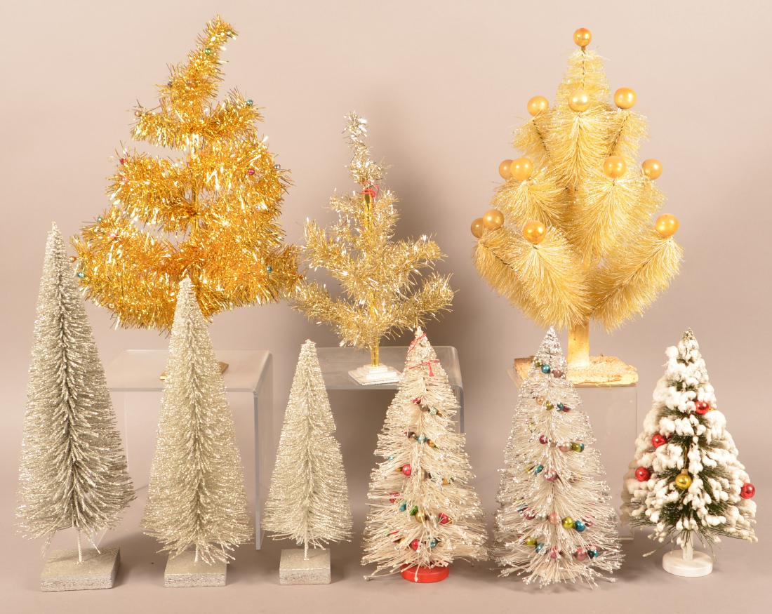 Nine Various Vintage Christmas Trees. Four with glass: Nine Various Vintage Christmas Trees. Four with glass ball ornaments. Tallest measures 20"h. Condition: Good with minor wear.
