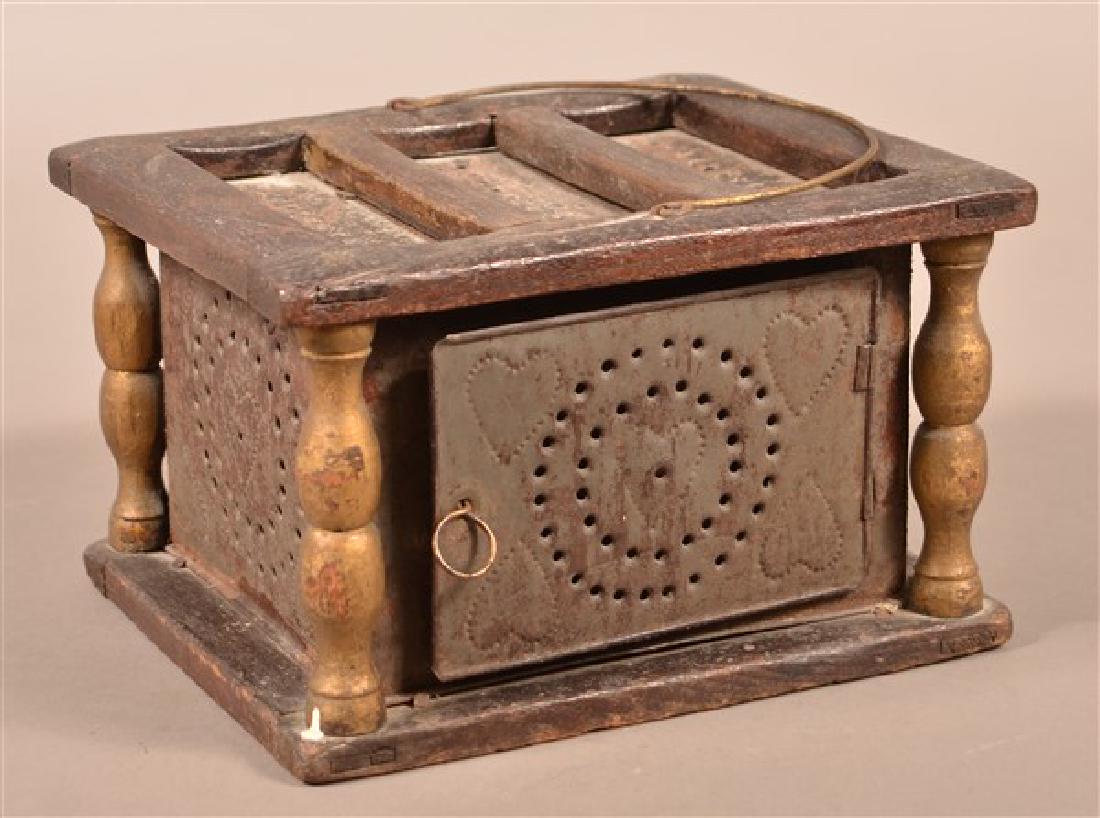 Pennsylvania 19th Century Wood and Tin Foot Warmer.: Pennsylvania 19th Century Wood and Tin Foot Warmer. Punched heart design with ember tray. 5-1/2"h. x 9"w. x 8'd. Condition: Fair to good with wear and losses.