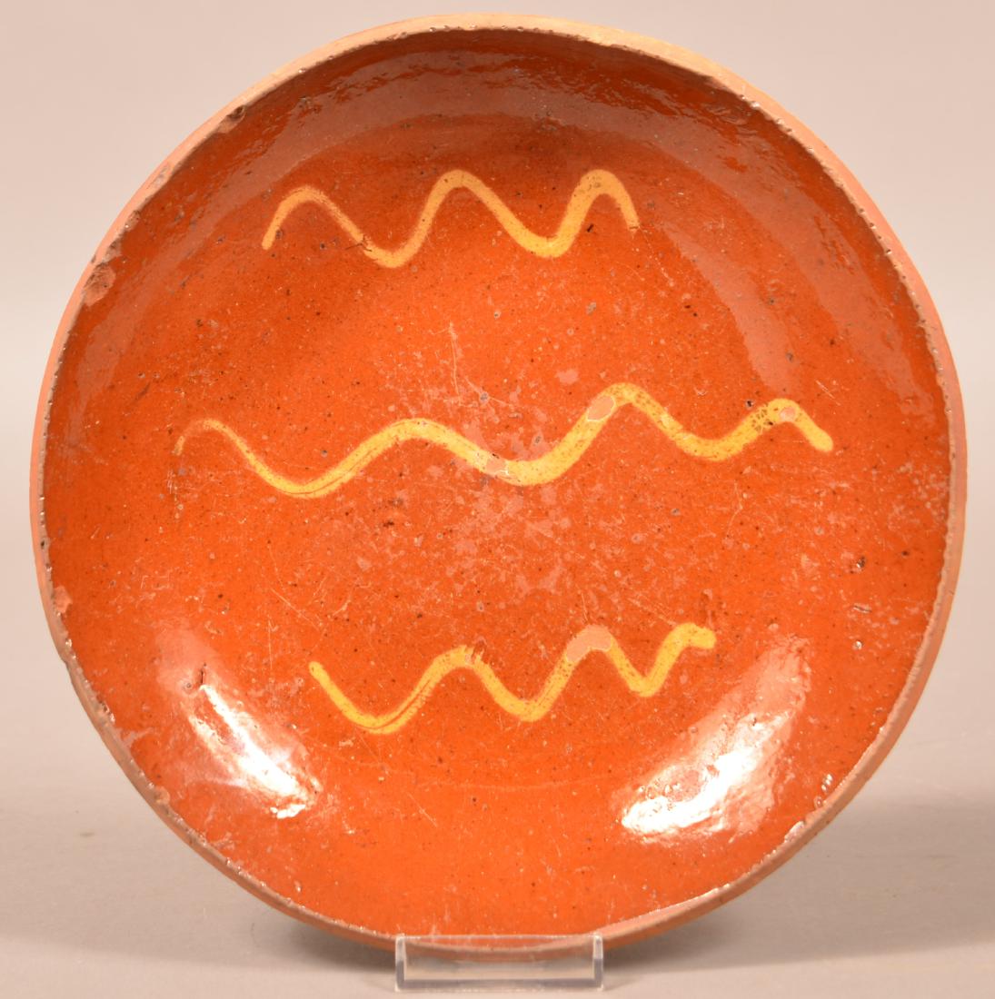 Redware Yellow Slip Decorated Plate.: 19th Century Redware Yellow Slip Decorated Plate. 9" diam. Condition: Good with edge chips.