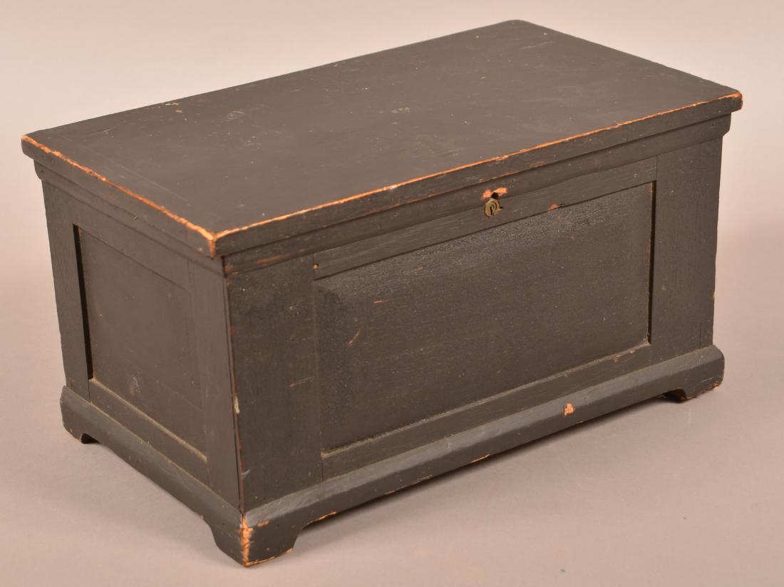 Black Painted Softwood Miniature Chest.: 19th Century Black Painted Softwood Miniature Chest. Paneled front and sides with bracket base. 8"h. x 15-1/4"w. x 8-1/2"d. Condition: Good with wear and loss to feet.