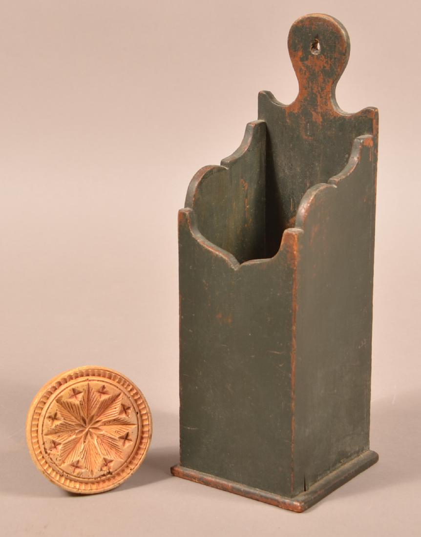 Two Pieces of Antique PA Woodenware.: Two Pieces of Antique Pennsylvania Woodenware. Floral and star design butter print, 3-3/4" diam. And a green painted wood pipe box, 13-1/4"h. Condition: Good with use wear.