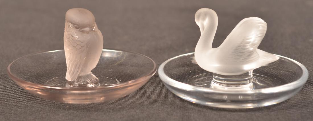 Two Lalique Frosted Crystal Figural Ring Caddie's.: Two Lalique Frosted Crystal Figural Ring Caddie's. Fledgling bird and swan. Both measure 2-1/4"h. x 3-3/4" diam. Condition: Very good.