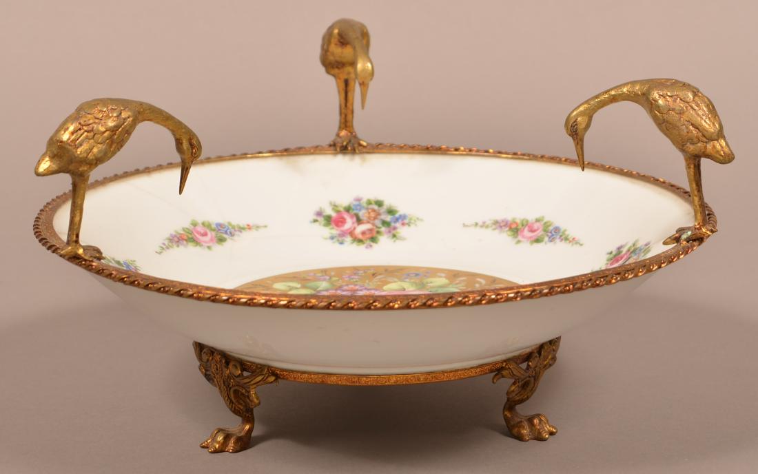 Limoges Ormolu Mounted Porcelain Bowl.: Limoges Ormolu Mounted Porcelain Bowl. Hand painted and transfer decorated with polychrome floral and foliate designs. 7"h. x 12-1/2" diam. Condition: Good with hairlines.
