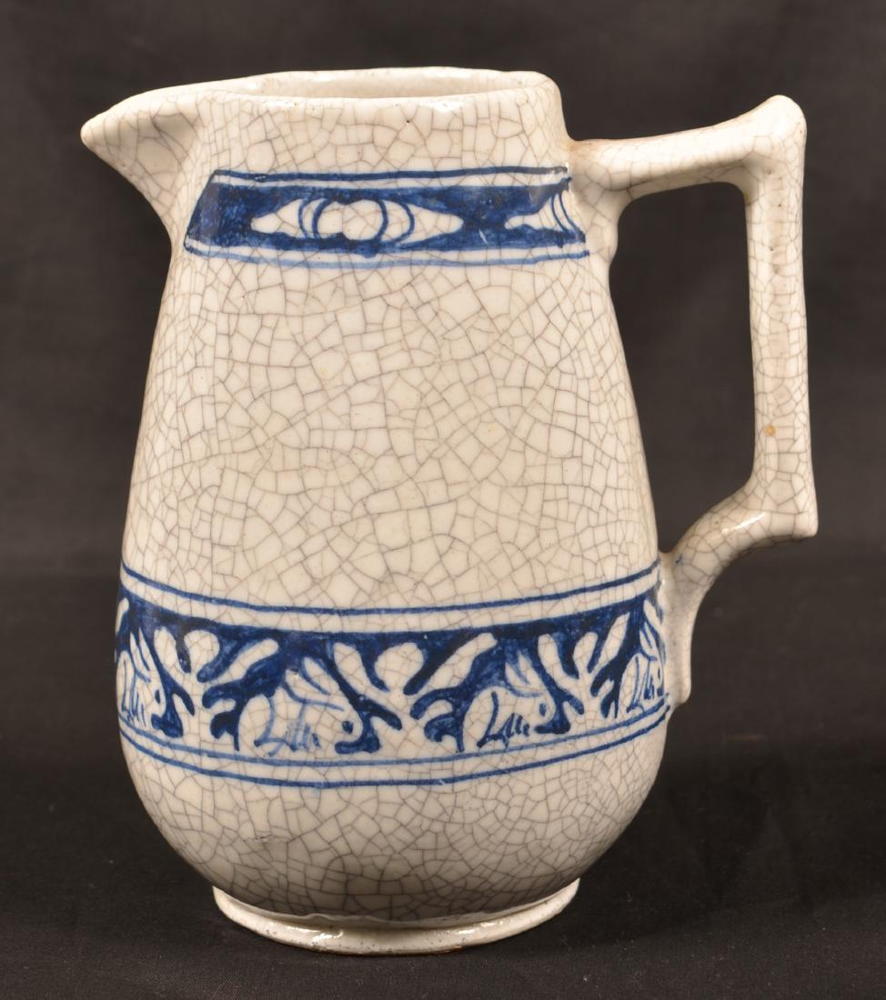 Dedham Pottery Two Ear Rabbit Pitcher.: Dedham Pottery Two Ear Rabbit Pitcher. Blue decoration on white crackle glaze. 1896-1943 blue printed mark. Tapered bulbous body with double band decoration. 7"h. Condition: Very good.