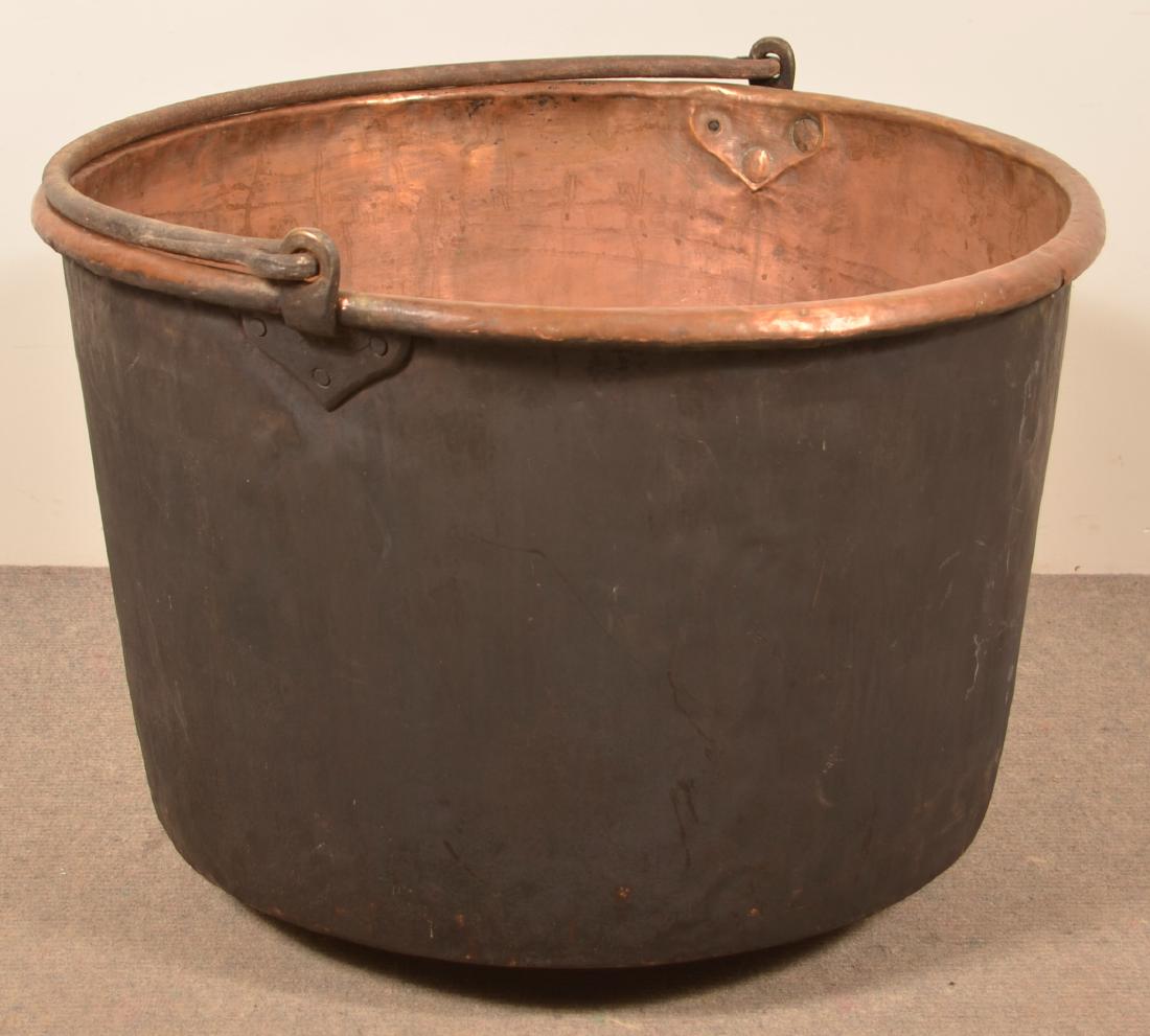 PA 19th Century Copper Apple Butter Kettle.: Pennsylvania 19th Century Copper Apple Butter Kettle. Cast iron handle tabs, iron bail handle and crimped seam tabs. 29-1/2"h. Condition: Good with dents and wear.