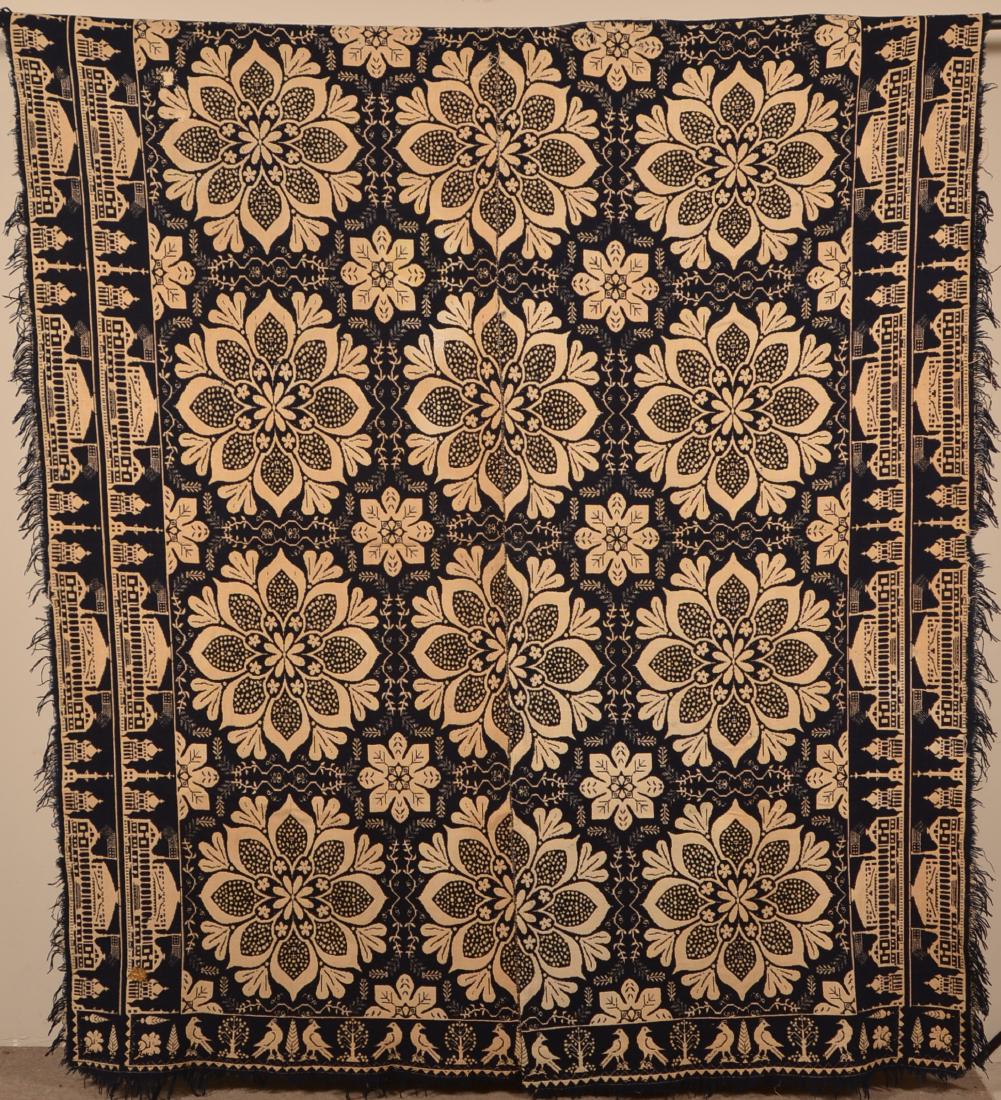 Blue & Neutral Two Part Jacquard Coverlet.: Pennsylvania Mid 19th Century Blue and Neutral Two Part Woven Jacquard Coverlet. Unsigned. Capitol and bird borders. 76" x 88" not including fringe. Condition: Good with wear and repair.