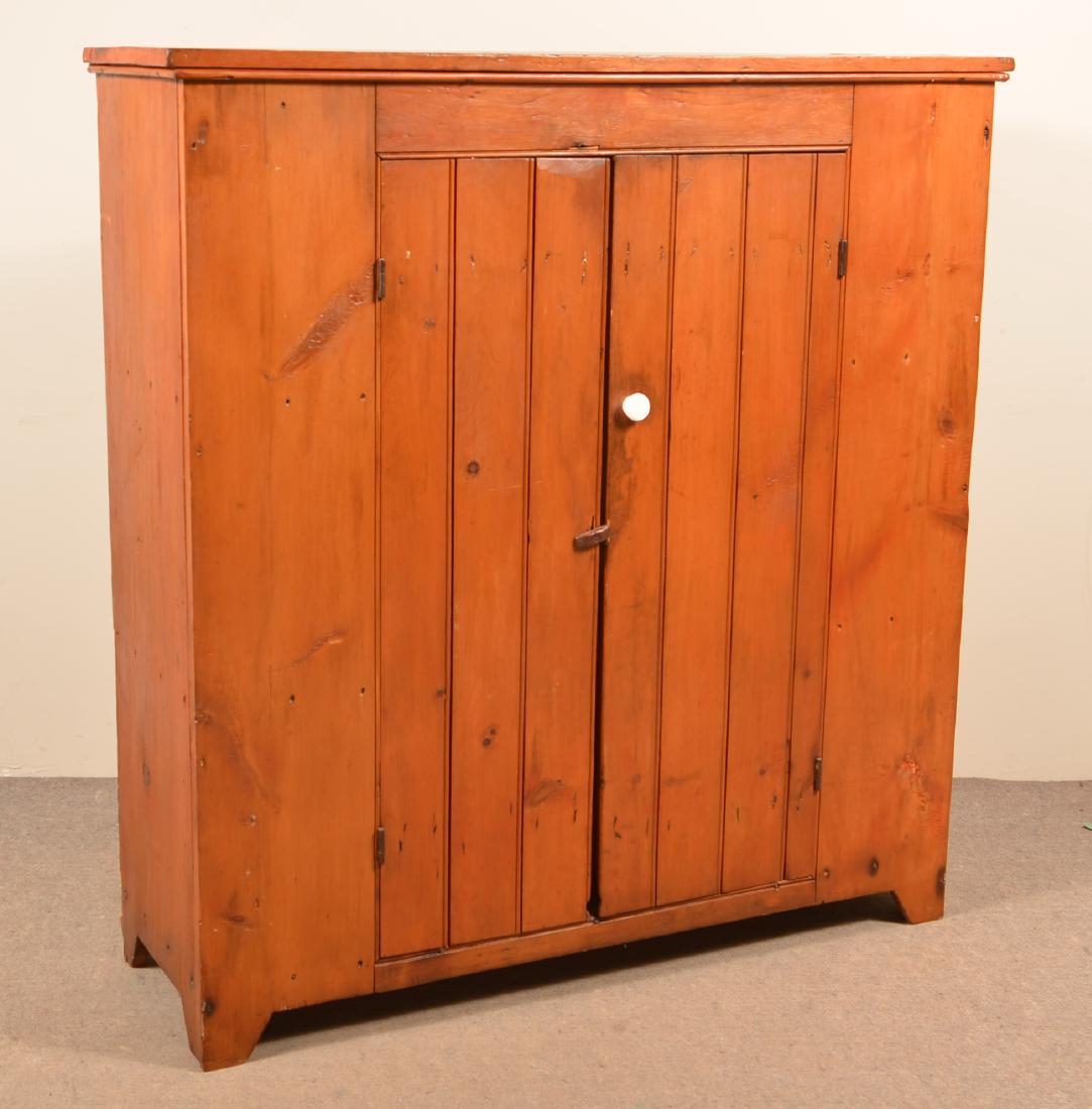 19th Century Softwood Wall Cupboard.: 19th Century Softwood Wall Cupboard. Tongue and groove doors, interior shelves and tapered cut-out feet. 53"h. x 49-1/2"w. x 17"d.Condition: Good with minor losses and repairs. Refinished with remnant
