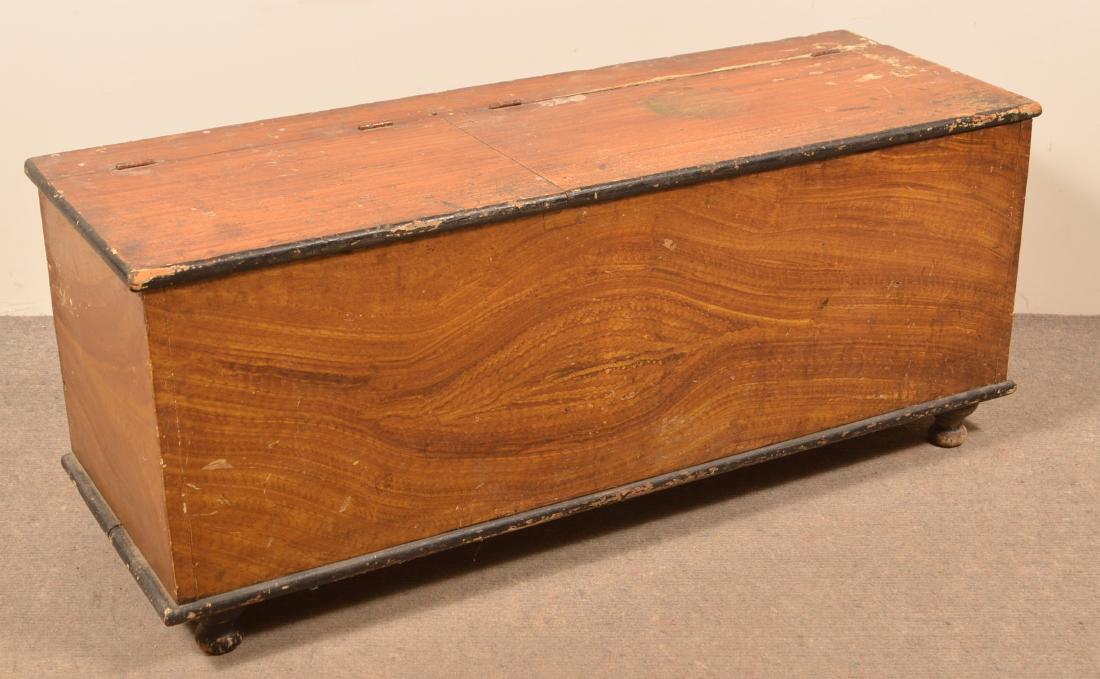 Lancaster County Grain Decorated Wood Box.: Lancaster County, PA Pine Grain Paint Decorated Wood Box. Double hinged lid, molded base, turned feet. 19-1/2"h. x 48"w. x 17-1/4"d. Condition: Good with wear.