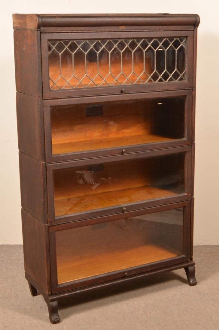 Lundstrum Quarter Sawn Oak Stacking Bookcase.: Lundstrum Quarter Sawn Oak Four Sectional Stacking Bookcase. Leaded glass upper section. 56-1/2"h. x 34"w. x 14"d. Condition: Good with minor wear.