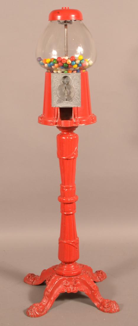 Cast Metal Gum Ball Machine with Pedestal Base.: Cast Metal Gum Ball Machine with Pedestal Base. 40"h. Condition: Good with wear.
