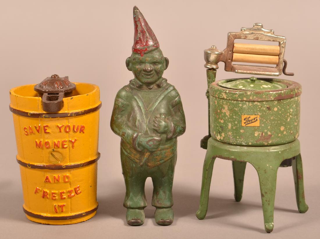 2 Cast Iron Still Banks and a Toy Washing Machine. (1 of 2)