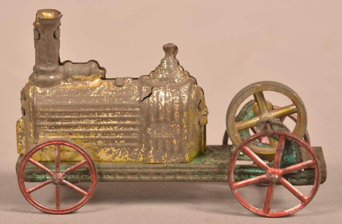 CR, France Tin Penny Toy Locomotive.: CR, France Tin Penny Toy Locomotive. Flywheel drive with cast spoke wheels, Circa. 1880. 4"l. Condition: Fair with wear and paint loss. Light scattered rust.