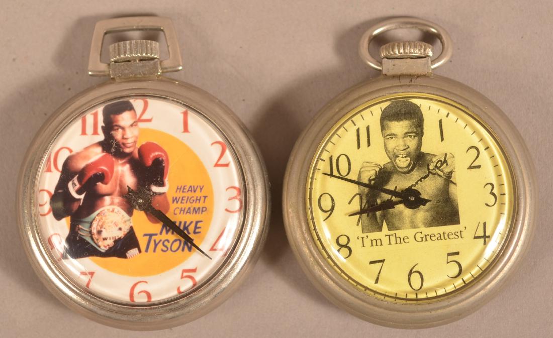 Mike Tyson and Muhamid Ali Pocket Watches.: Mike Tyson and Muhamid Ali Pocket Watches. Photographic dials, both movements marked "Made in U.S.A.". Cases measure 2" diam. Condition: Good with wear.