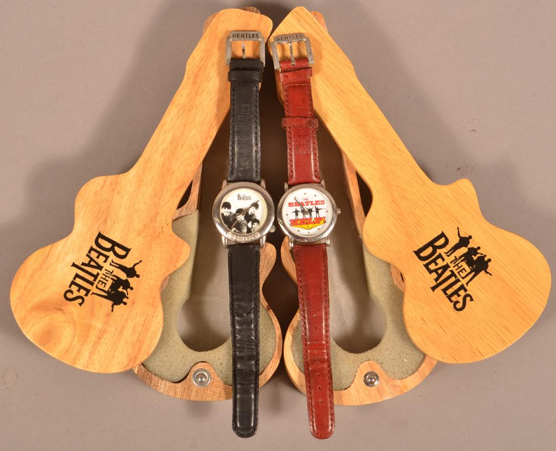 Two "The Beatles" 1990's Wrist Watches.: Two "The Beatles" 1990's Wrist Watches. With wood guitar form cases. Condition: Good with wear.