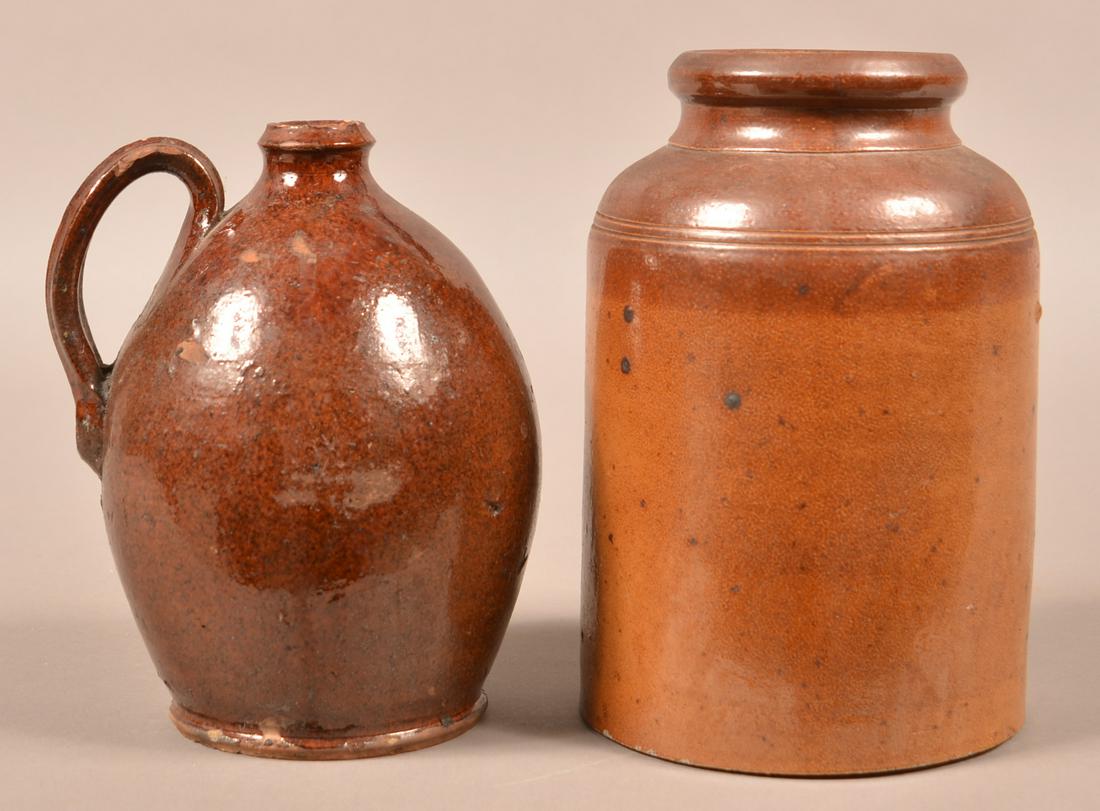 Two Pieces of Antique Glazed Pennsylvania Pottery.: Two Pieces of Antique Glazed Pennsylvania Pottery. Redware Jug, 7-1/2"h. and a stoneware storage jar. 8-1/2"h. Condition: Good with some small chips and wear.