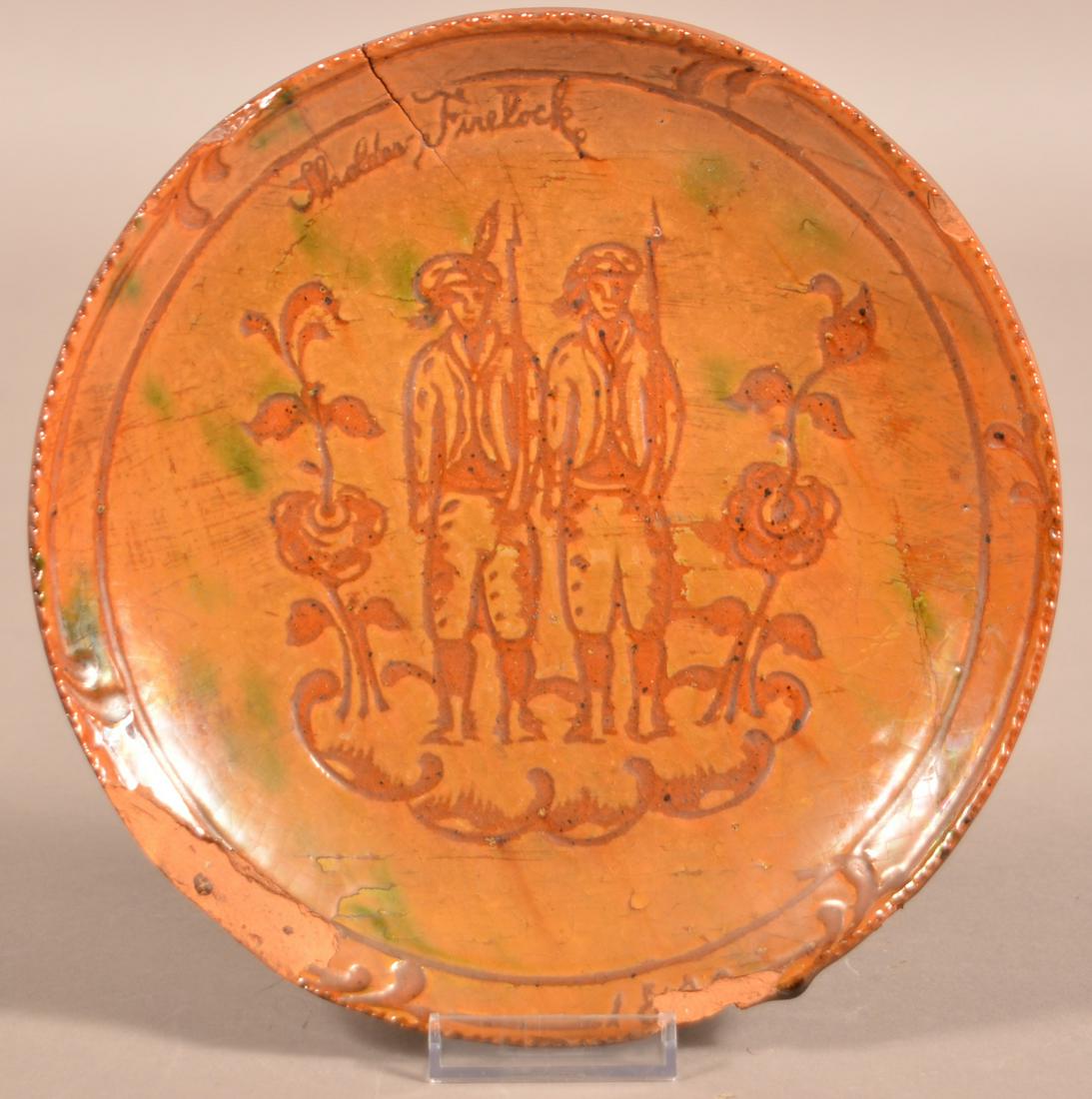 Medinger Sgrafitto "Shoulder Firelock" Redware Plate.: Glazed Sgrafitto "Shoulder Firelock" Redware Plate Attributed to Medinger Pottery. (Jacob Medinger, 1856-1932, Limerick Township, Montgomery County, PA). Incised with two militia men holding flintlock