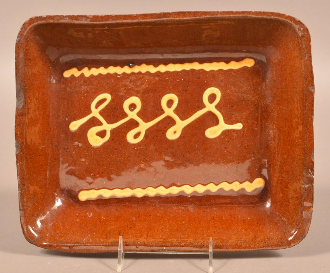 19th Century Yellow Slip Glazed Redware Loaf Dish.: 19th Century Yellow Slip Glazed Redware Loaf Dish. 12-1/4"w. Condition: Good with edge chips.