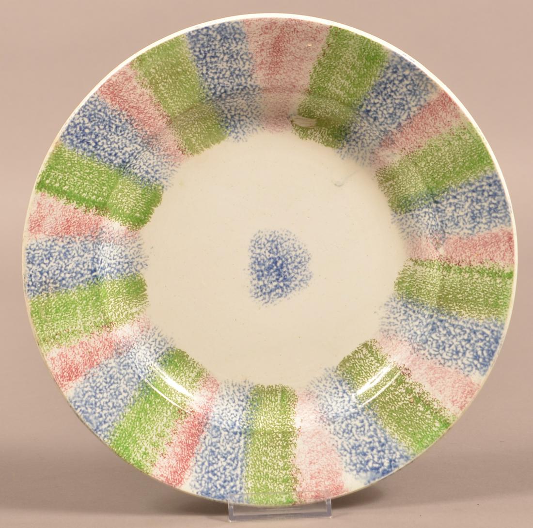 Three Color Rainbow Spatter Ironstone China Plate.: Three Color Rainbow Spatter Ironstone China Plate. Alternating bands of red, green and blue rainbow design. 9-1/2" diam. Condition: Good with chips (only visible from the back).
