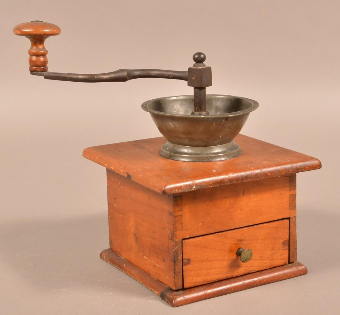Antique Philadelphia Cherry Coffee Mill.: Antique Philadelphia Cherry Coffee Mill. Stamped on metal facet "G. Minnick, Patent, Philada.". Dovetailed case and lower drawer, tin hopper, cast iron gears and crank with turned wood grip. 9-1/2"h. 