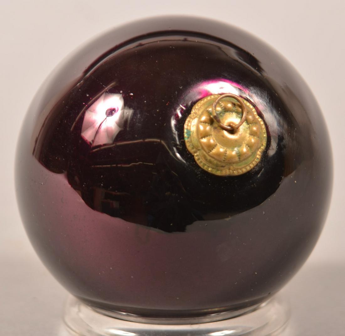Antique German Amethyst Glass Ball Form Kugel.: Antique German Amethyst Glass Ball Form Kugel. Daisy cap. Pictured in "Kugels: An Antique Christmas Obsession" by Joseph Krisky. 3-1/4" diam. Condition: Very good.