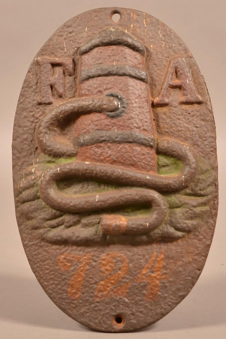 Philadelphia Issue of 1863 Cast Iron Fire Mark.: Philadelphia Issue of 1863 Cast Iron Fire Mark. "FA" Hose with Barrel. Fire Association of Philadelphia. Original polychrome paint, numbered "724". 11-1/4"h. Condition: Good with typical rust and pitt