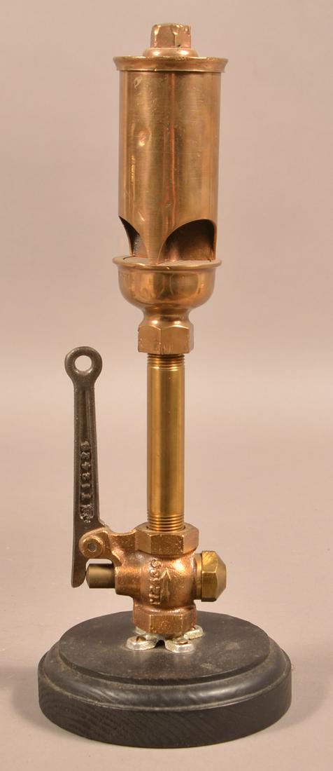 Antique Crosby Brass Steam Whistle: Antique Crosby Brass Steam Whistle. Marked "Crosby Steam Gauge & Valve Co., Boston, U.S.A.". Mounted on a molded wood platform Base. 15"h. overall. Condition: Good with minor dents and wear.